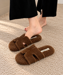 Cozy Brown Fuzzy Slippers on Carpet.png